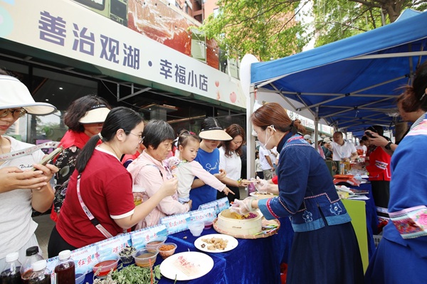 20260428177734835871.jpg 深圳市民在幸福小店门前品尝东兰特色美食.jpg